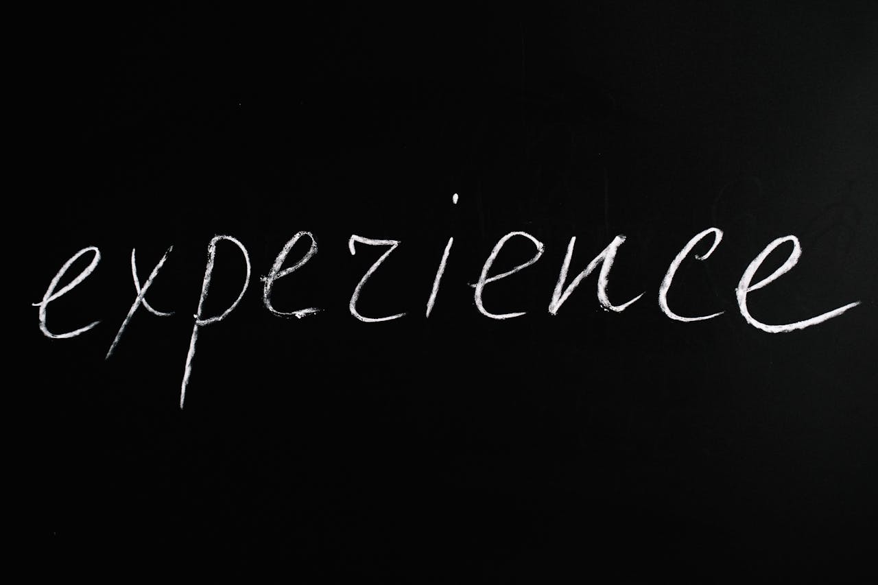 Chalkboard showing expezience, emphasizing creativity or error.